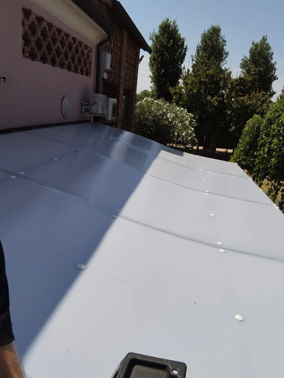 Polycarbonate sheets laid on the structure, seen from above during installation