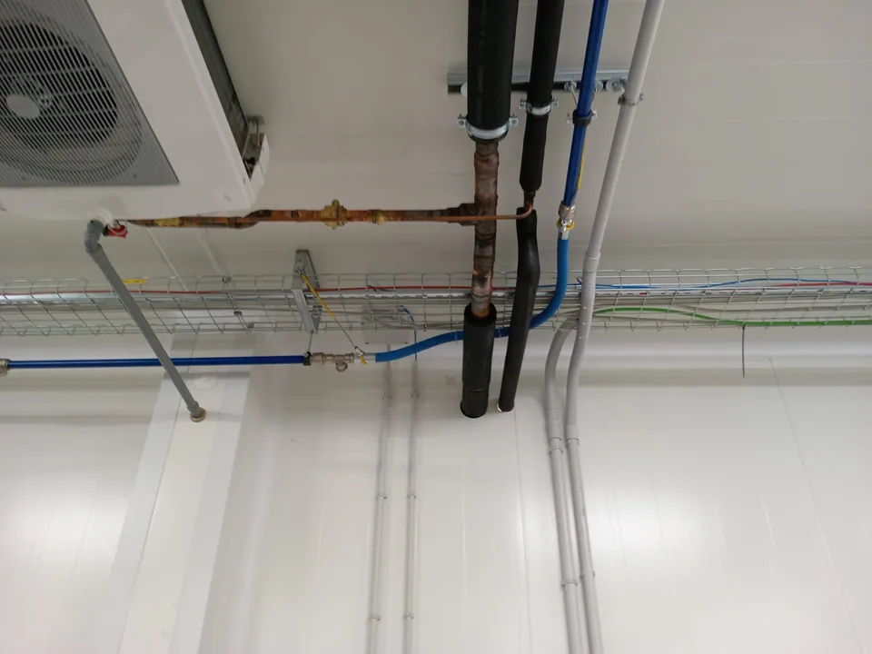 Pipes and cable ducts installed on the ceiling of a processing room