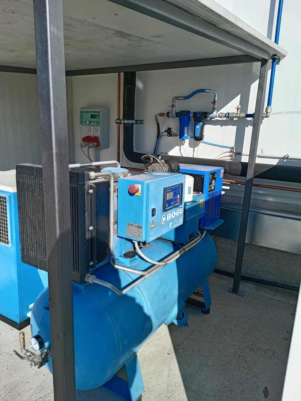 Compressor mounted on its air receiver, with the dryer alongside, under the service canopy