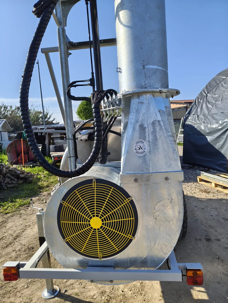 Close-up of the blower with yellow safety guard at the base of the column