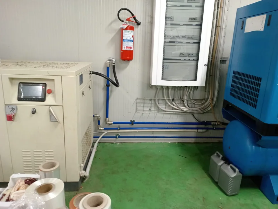 Compressor room with electrical panel and new pipework run at floor level