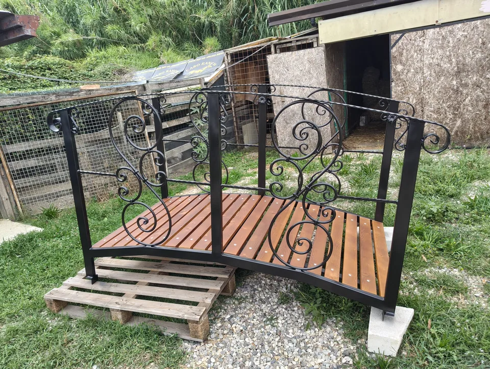 Finished footbridge in three-quarter view, with the scrollwork railings