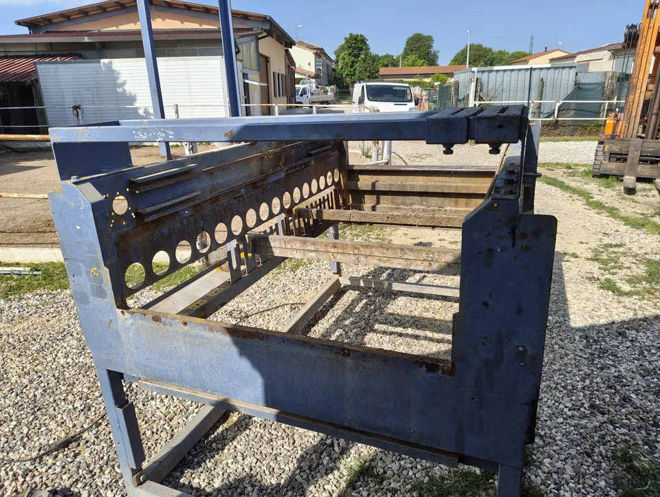 Machine frame stripped down outdoors, before reassembly