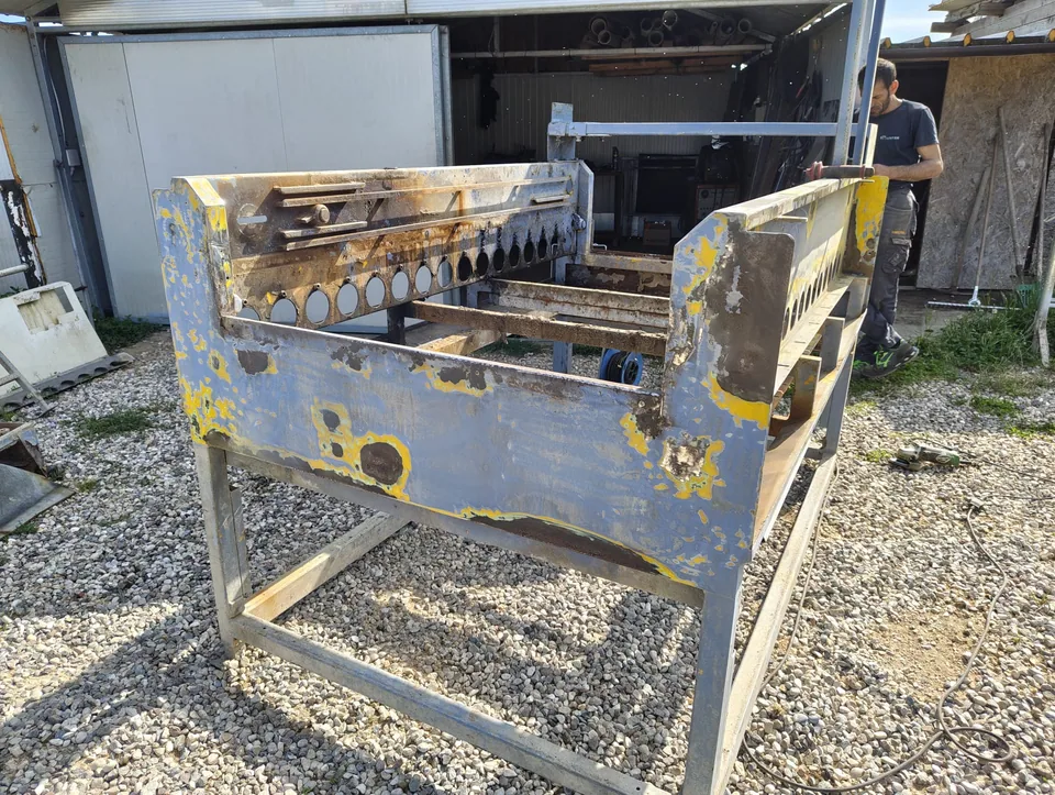 Machine frame as received, with flaking paint and rust