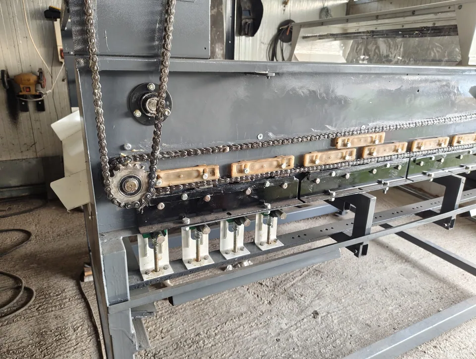 Close-up of the wear pads and drive chain on the overhauled machine