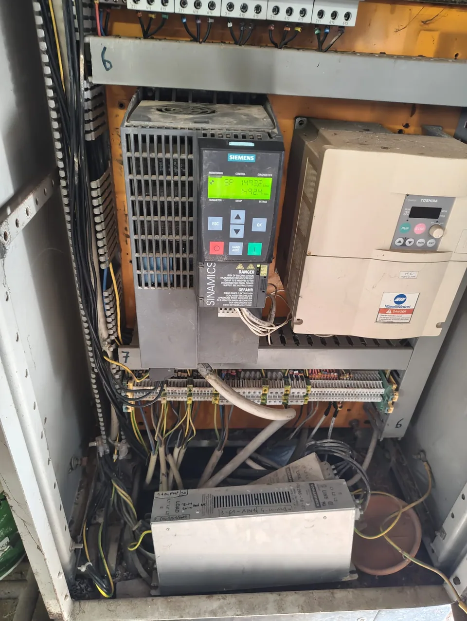 Open electrical panel with the new inverter installed next to the one it replaced